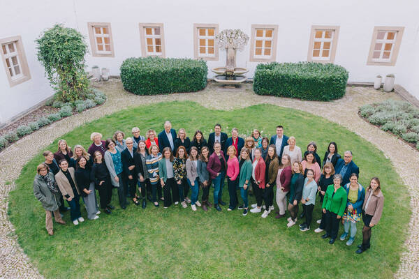 Gruppenfoto der Mentees, Mentor*innen, Mitglieder der Programmsteuerungsgruppe und Verantwortlichen des Hildegardis-Vereins auf einer Rasenfläche